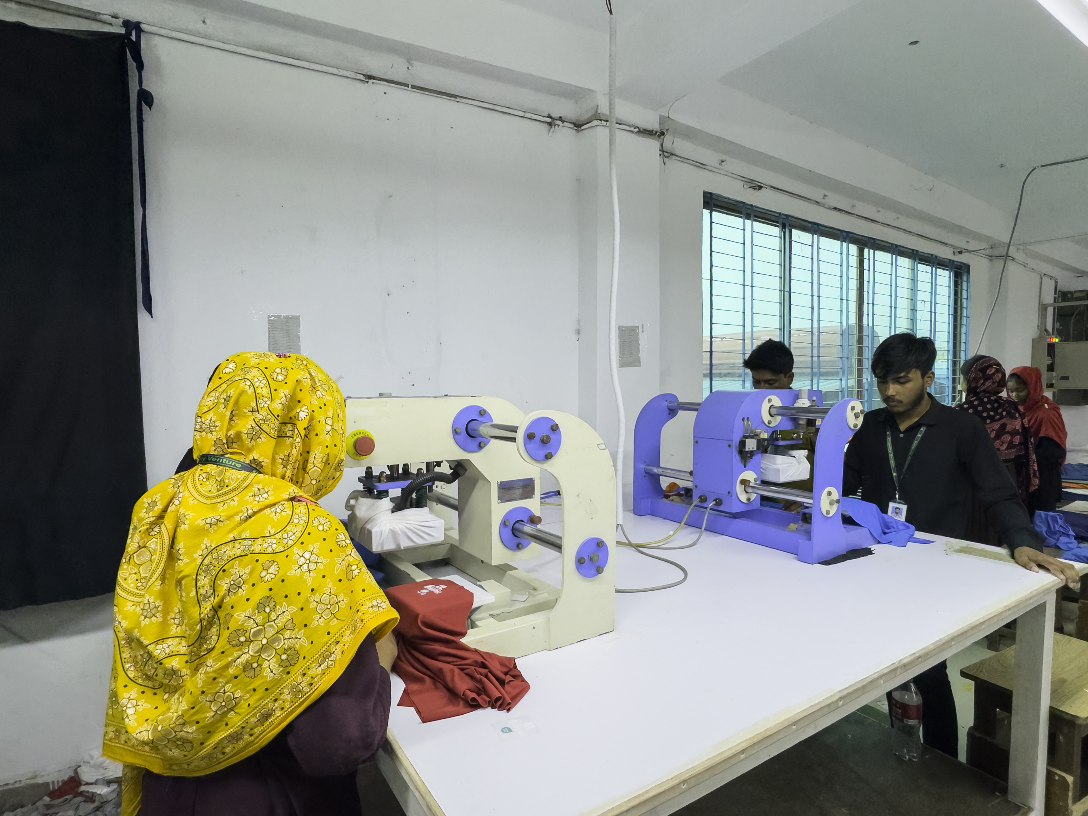 Ironing and finishing line, workers pressing garments