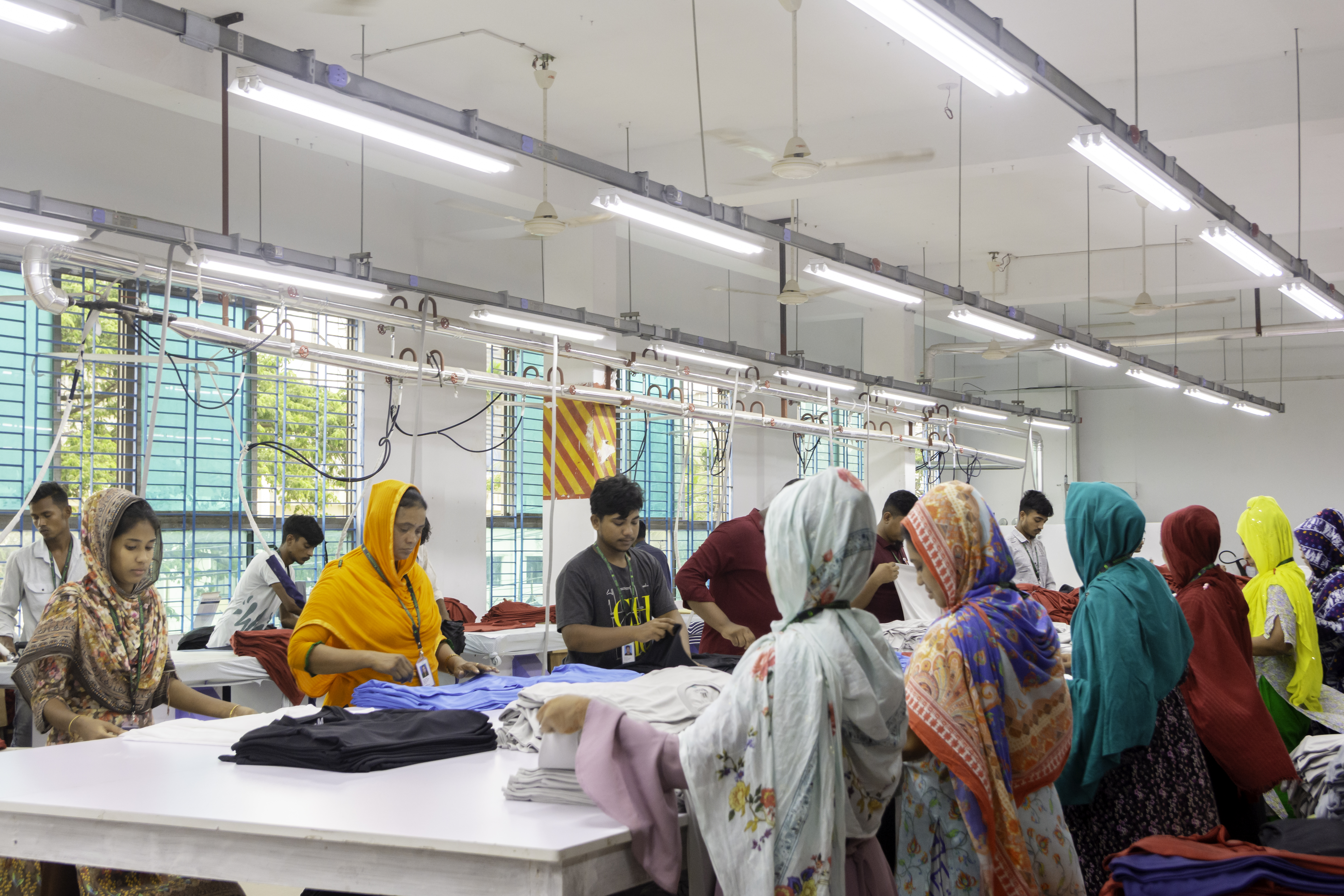 Meeting room with sample garments on a rail beside the conference table